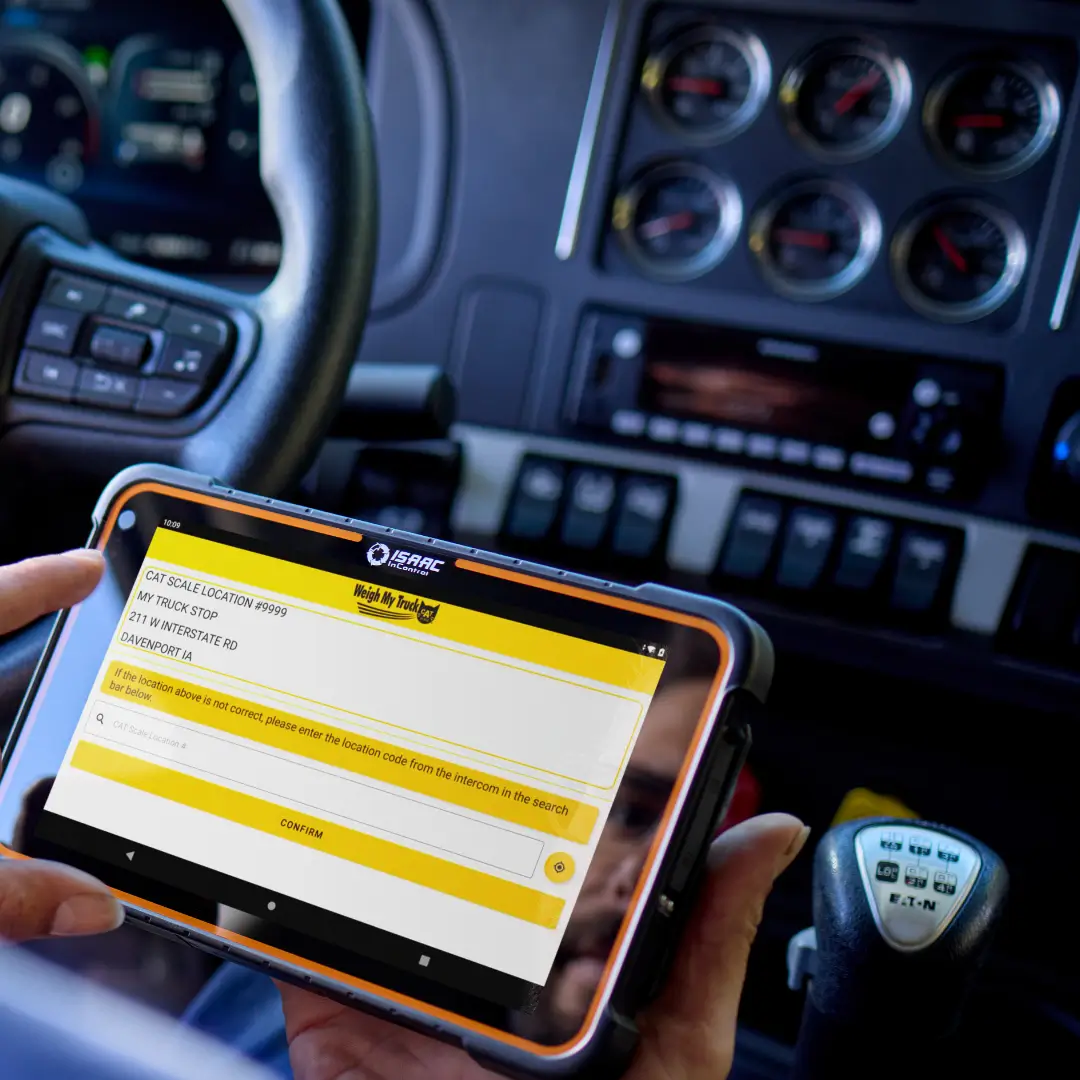 isaac-platform-truck-dashboard-tablet-weigh-scale Truck driver using ISAAC platform on a tablet to weigh the truck at a scale.
